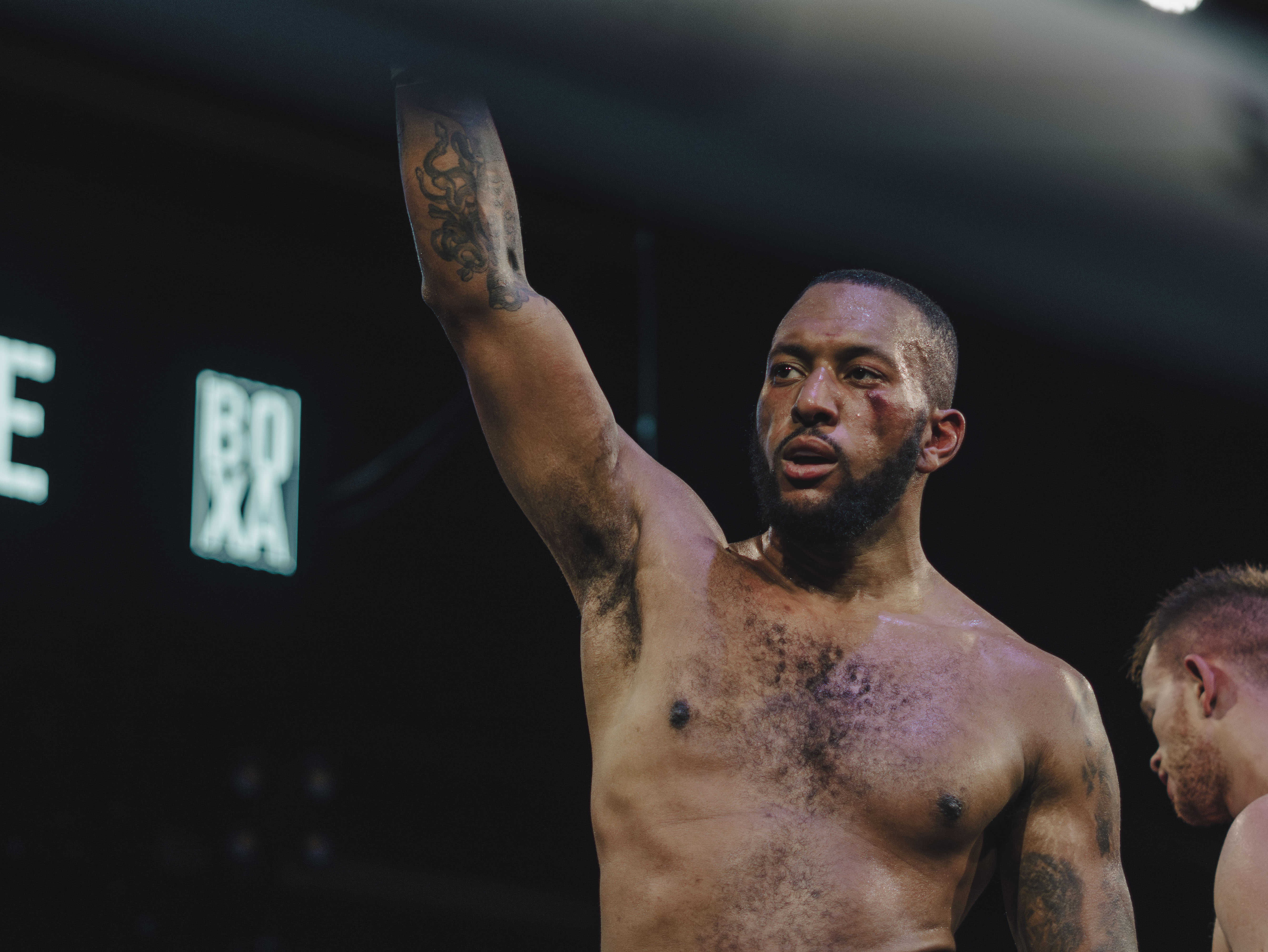 Victorious champion boxer with raised arm celebrating victory, embodying the fighting spirit and determination needed to dominate social media and build a successful personal brand